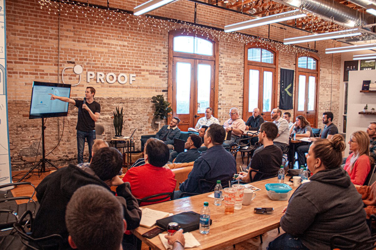 A speaker in conversation with a conference audience